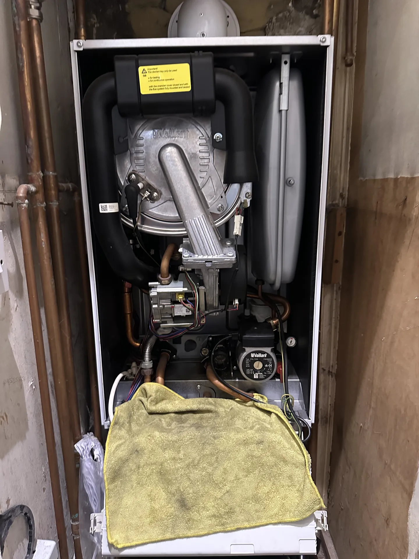 Boiler with the cover off during a heating system leak inspection