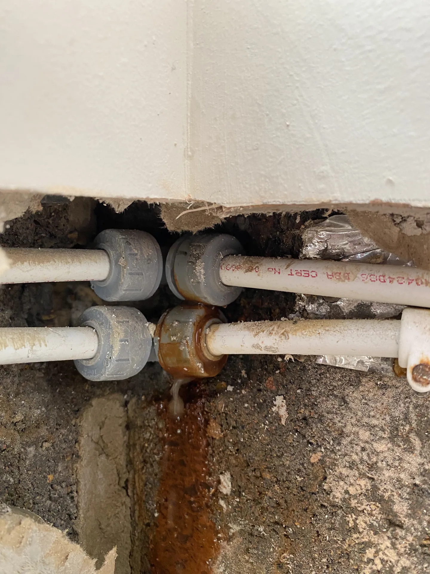 Leaking pipe joint inside a wall with the staining it caused