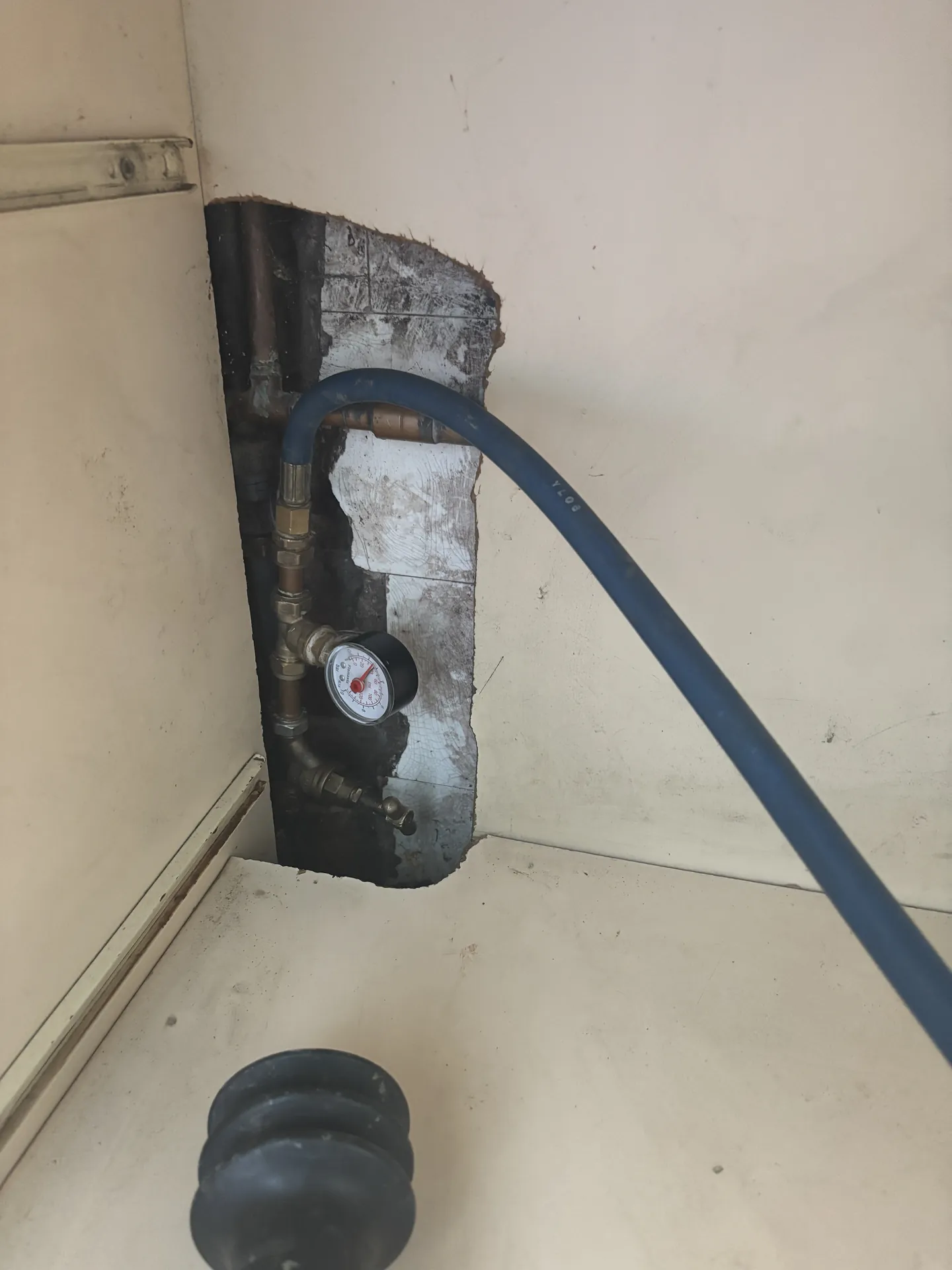 Small pipe chase opened in a wall exactly where the leak was located