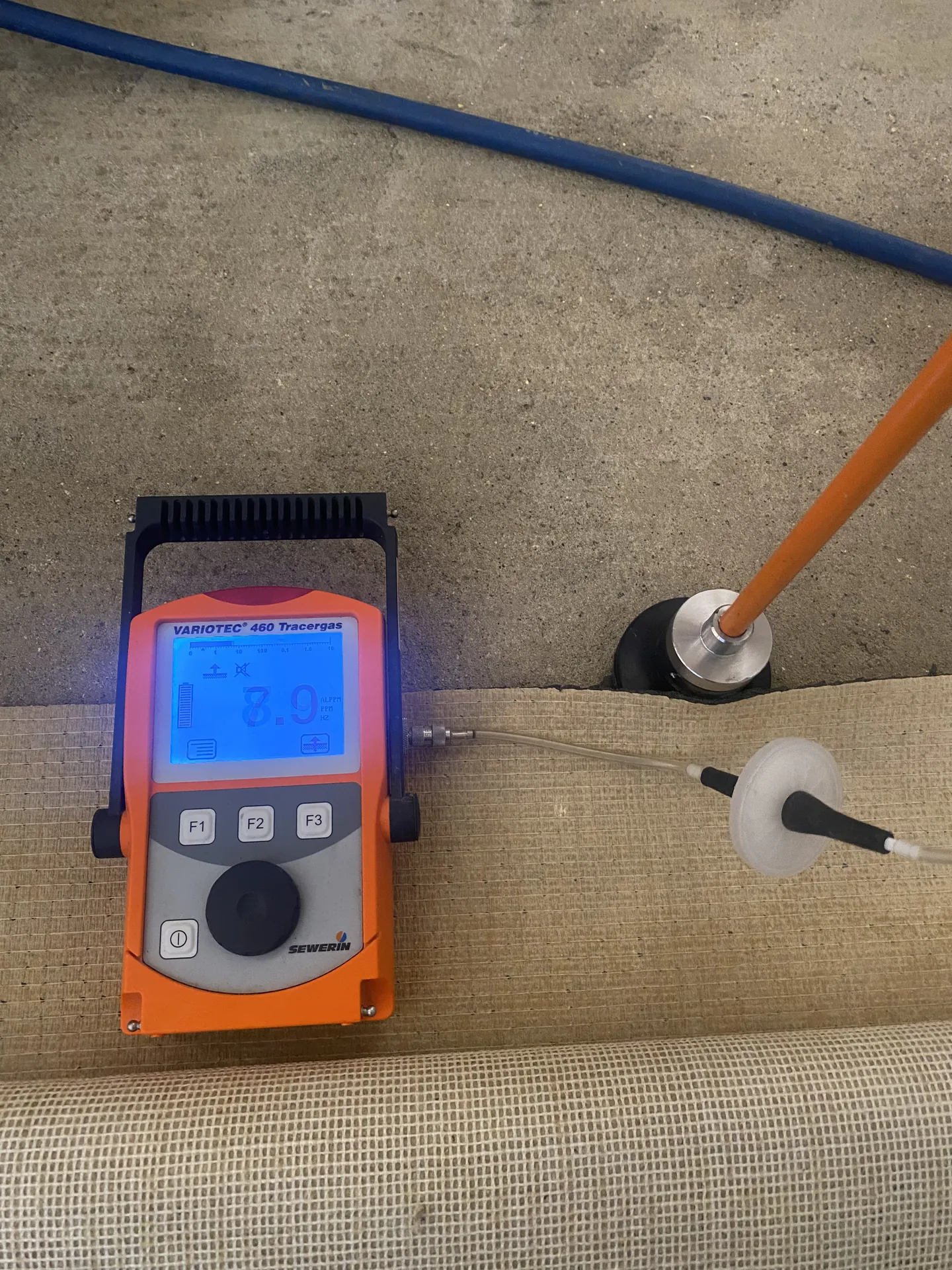 Tracer gas detector sampling through a carpet without lifting it